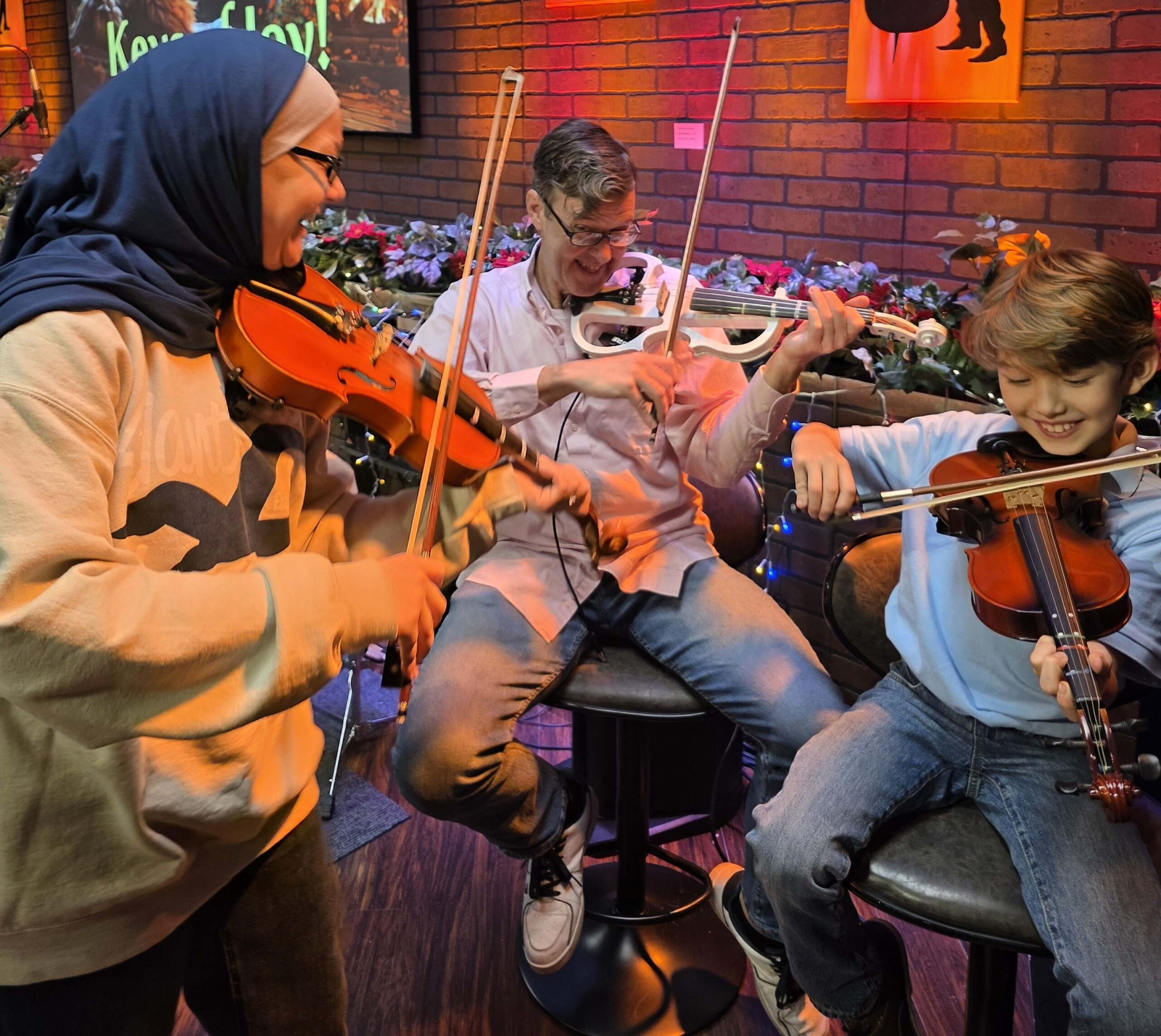 Students enjoying violin lessons at Keys of Joy! Studio in Lawrence, KS