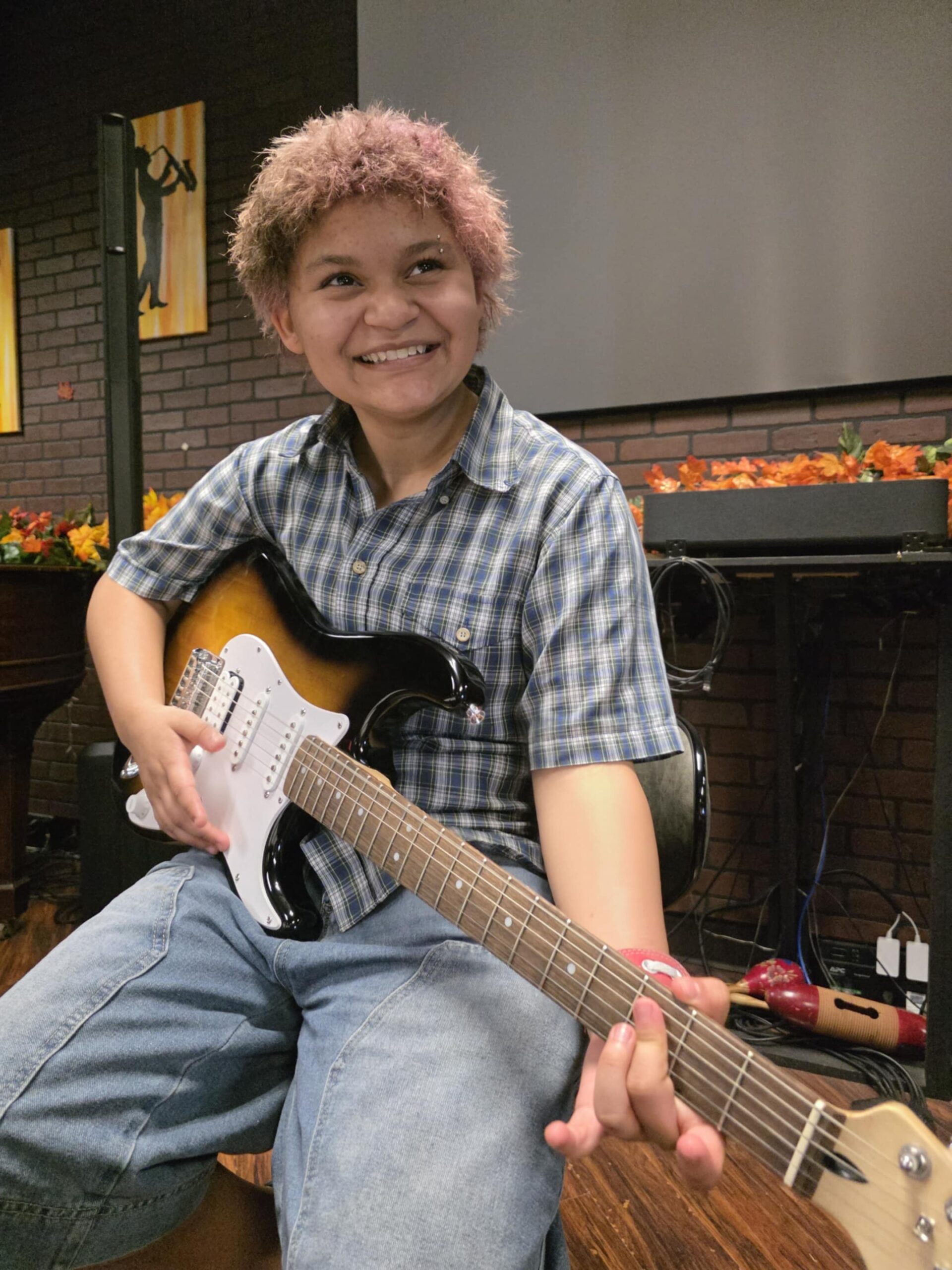 Student playing guitar at Keys of Joy! Studio in Lawrence, KS